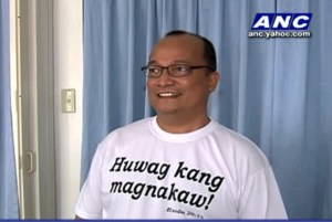 Fr. Fajardo wearing t-shirt that says, 'Thou Shall Not Steal'