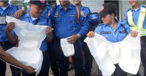 Philippine police try on adult diapers for size in preparation for Pope Francis' visit next week