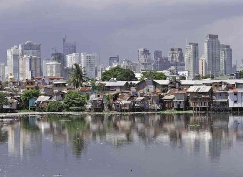 Skyline of the affluent Makati City in the Philippines (background), slums (foreground)