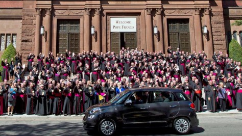 U.S. bishops welcome Pope Francis in Washington, D.C., as he alights from a tiny Fiat