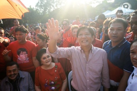 Bongbong Marcos, Jr. waves to supporters during his VP candidacy announcement. Seated far left is Estrada and Imelda Marcos